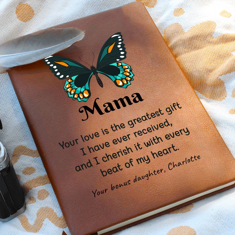 Brown leather notebook with butterfly design and heartfelt message on a patterned fabric background