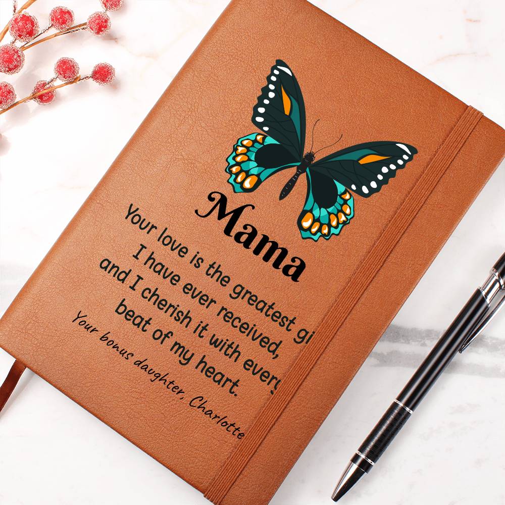 Brown notebook with butterfly design and engraved text on a white background