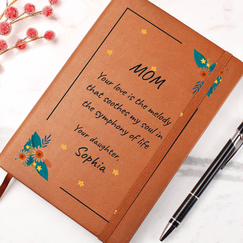 Brown notebook with floral designs and a heartfelt message to 'Mom' on a white background.