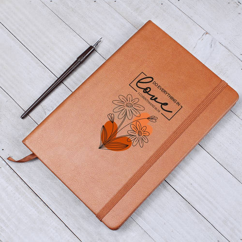 Side view of brown vegan leather notebook showing elastic closure band and ribbon page marker