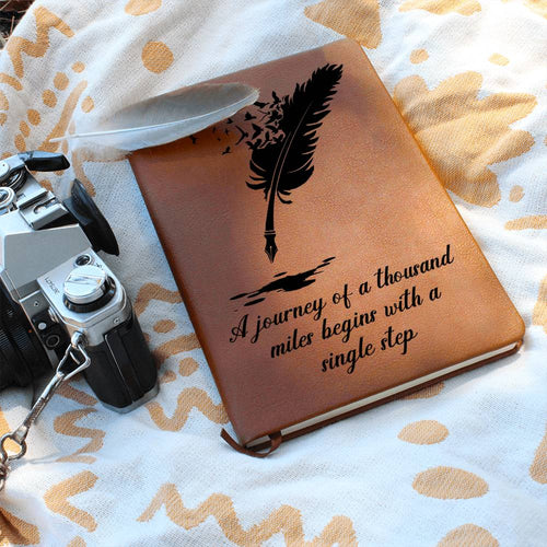 Inspirational brown vegan leather journal printed with scenic nature mountain quote reading Journey of a Thousand Miles