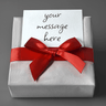 Close-up of hand-wrapped gift box with red ribbon and custom personalized message card