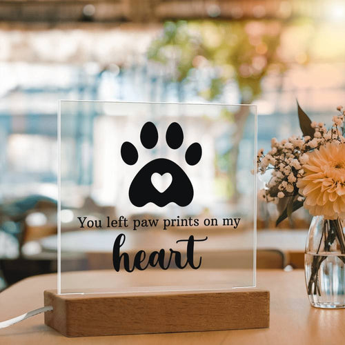 Pet loss memorial LED acrylic plaque reading You Left Paw Prints On My Heart on corded wooden light base