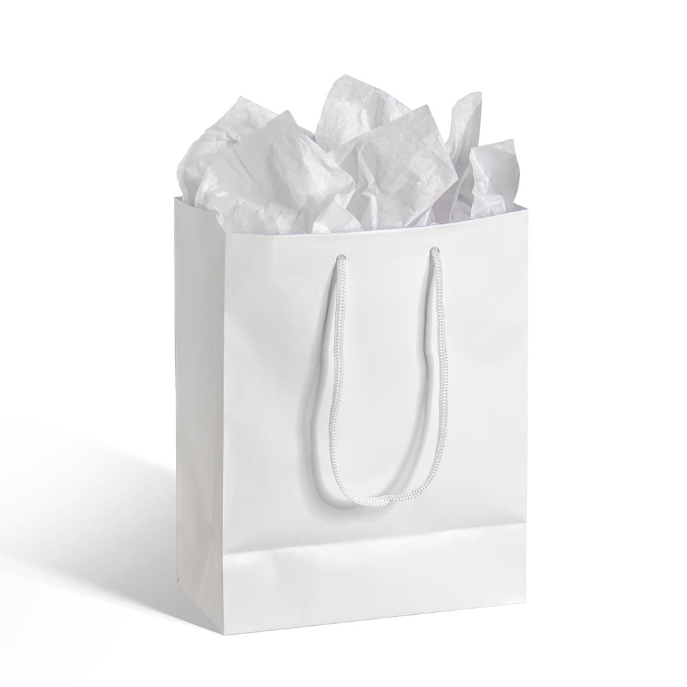 White paper medium gift bag with rope handles filled with matching white tissue paper