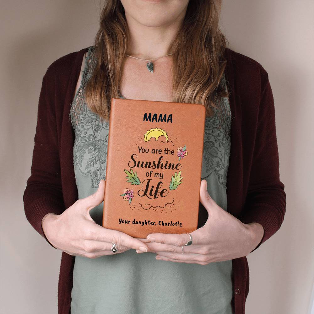Person holding a leather-bound book with personalized message